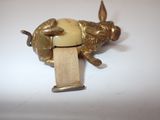 brass figurine of a dog with a bone in its mouth