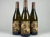 three bottles of wine sitting next to each other on a table