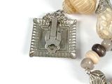 a picture of a necklace with beads and a clasp