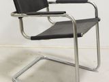 an image of a black leather chair with a metal frame