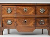 a wooden chest of drawers with a marble top
