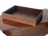 two wooden trays on top of each other on a table