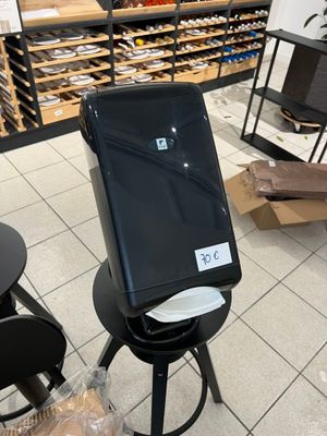 a laptop sitting on a stool in a store