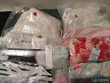 a pile of clothing that is packed in plastic bags