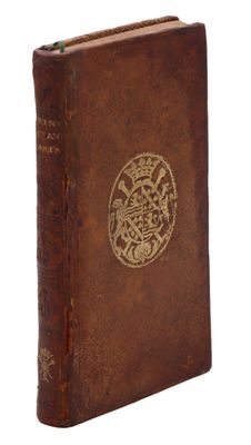 un vieux livre marron avec un motif doré sur la couverture