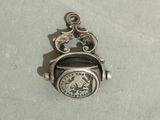 a small silver clock that is sitting on a table