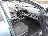 the interior of a car with the door open and the driver ' s seat down
