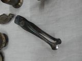 a lot of silver spoons and spoon rest on a table