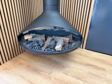 a fireplace with logs inside of it on a wooden floor