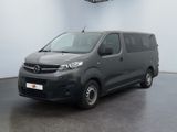 the grey van is parked in a large room