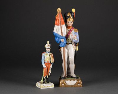 two figurines of a soldier and a soldier with a flag