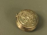 a gold locke with a picture on it sitting on a table