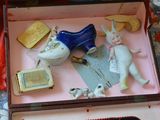 a small box with a doll in it on a table