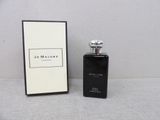a bottle of perfume sitting next to a box on a table