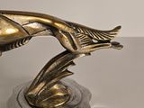 a statue of a fish on a stand on a table