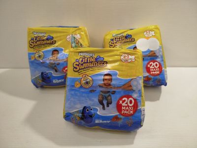 three packs of diapers sitting on top of a white counter
