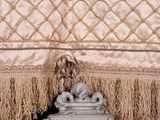 a picture of a bed with fringes on it