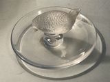 a glass plate with a fish figurine on it
