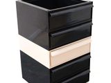 a black and white box with three drawers in it