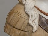 a bust of a woman with long hair wearing a hat