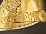 a gold helmet with a crown on it on a black background