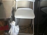 a white chair and a table in the corner of a room