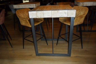 tables and chairs in a restaurant with wooden tops and metal legs