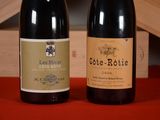 two bottles of wine sitting next to each other on a table