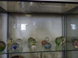 many glass vases on display in a glass case