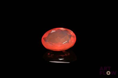 a close up of a red diamond on a black surface