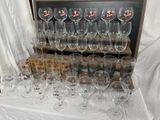 many wine glasses sitting on a table in front of a display case