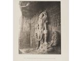 a black and white photo of a statue in a cave