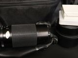 a camera lens and a camera case on a table