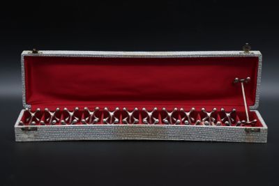 a silver and red box with a pair of scissors in it