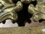 a close up of a gold plate with a clock on it