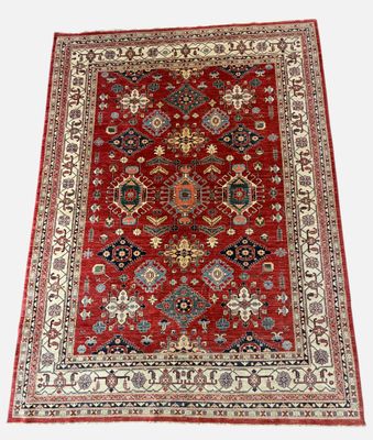 a red rug with a diamond design on it
