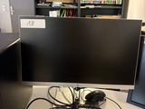 a computer desk with two monitors and a keyboard on it