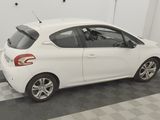 a picture of a small white car parked in a garage