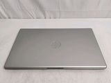 a laptop that is sitting on a bed with a white sheet