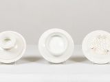 three white plates sitting on a table with a white background