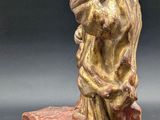 an image of a statue of a man holding a child