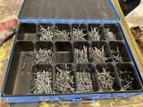 a blue case filled with lots of screws sitting on a table