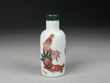 a white and green glass snuff bottle with a rooster on it