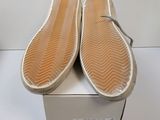 the soles of a pair of shoes are on top of a box