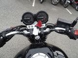 a close up of a motorcycle handlebar with a number of gauges on it