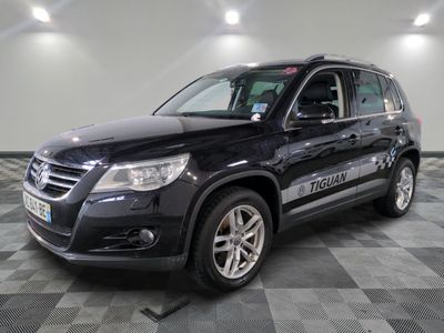 the black volkswagen suv is parked on a checkered tile floor