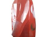 a red penguin statue that is on display on a white background