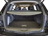 the back of a car with its trunk open and the back seats folded down