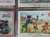 several cards with pictures of people and animals on them in a display case