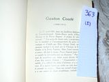 an open book with a piece of paper on top of it